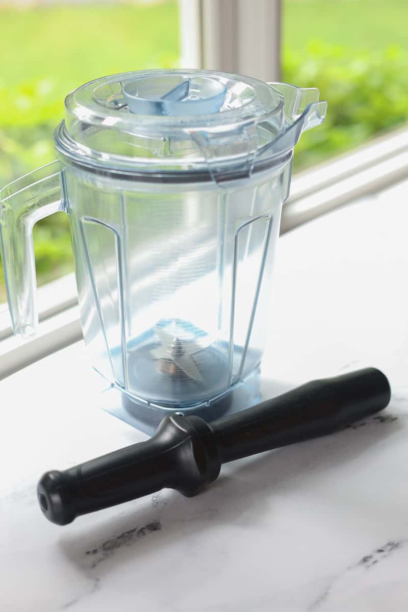 Tamper tool and container for Vitamix blender.