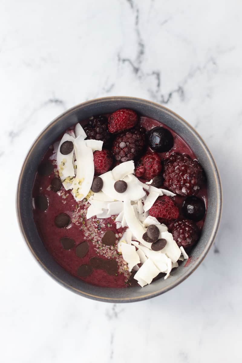Best acai smoothie bowl recipe in gray bowl on white marble countertop.