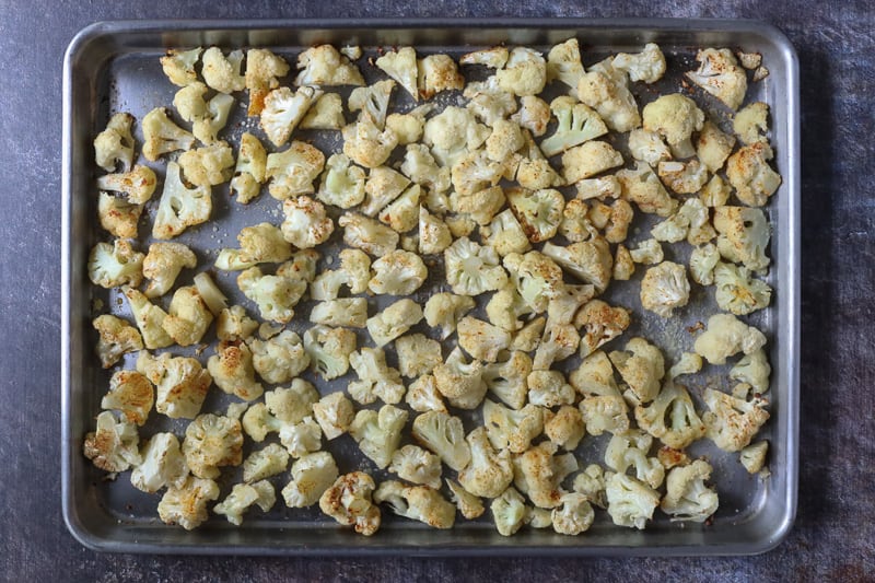 Roasted cauliflower on a sheet pan.