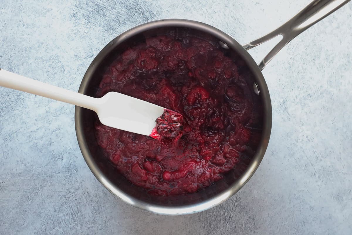 A small saucepan containing the finished cranberry sauce.