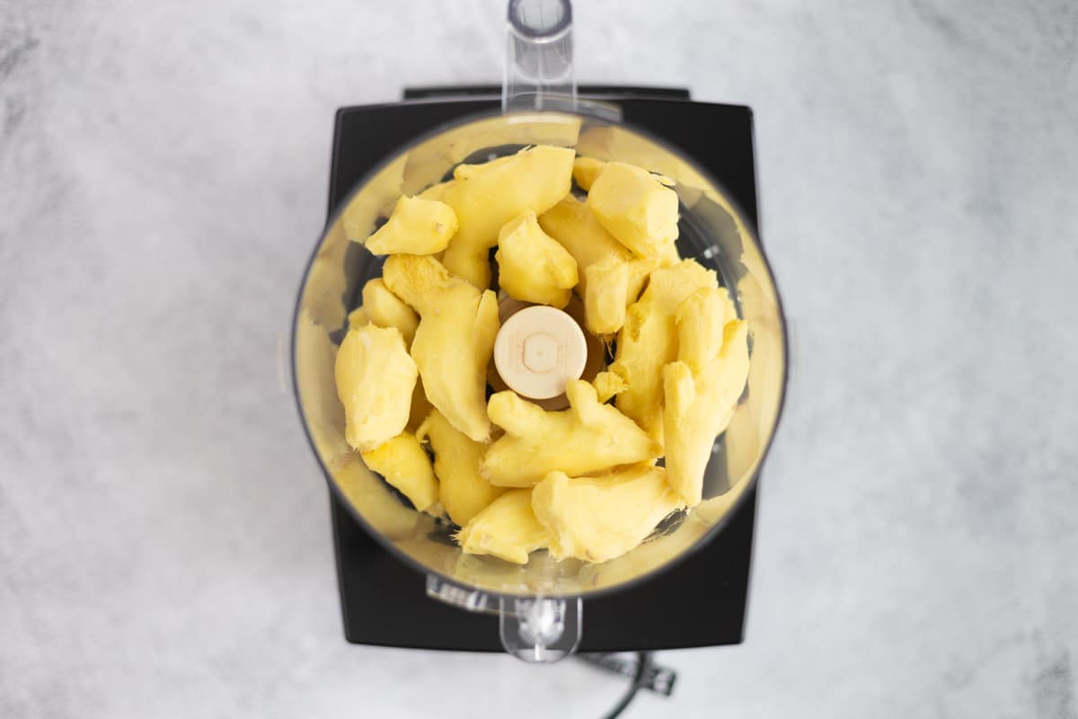 Peeling ginger root placed in a food processor.