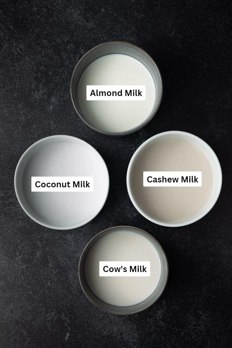 Three labeled bowls of plant-based milk and one bowl of cow's milk.