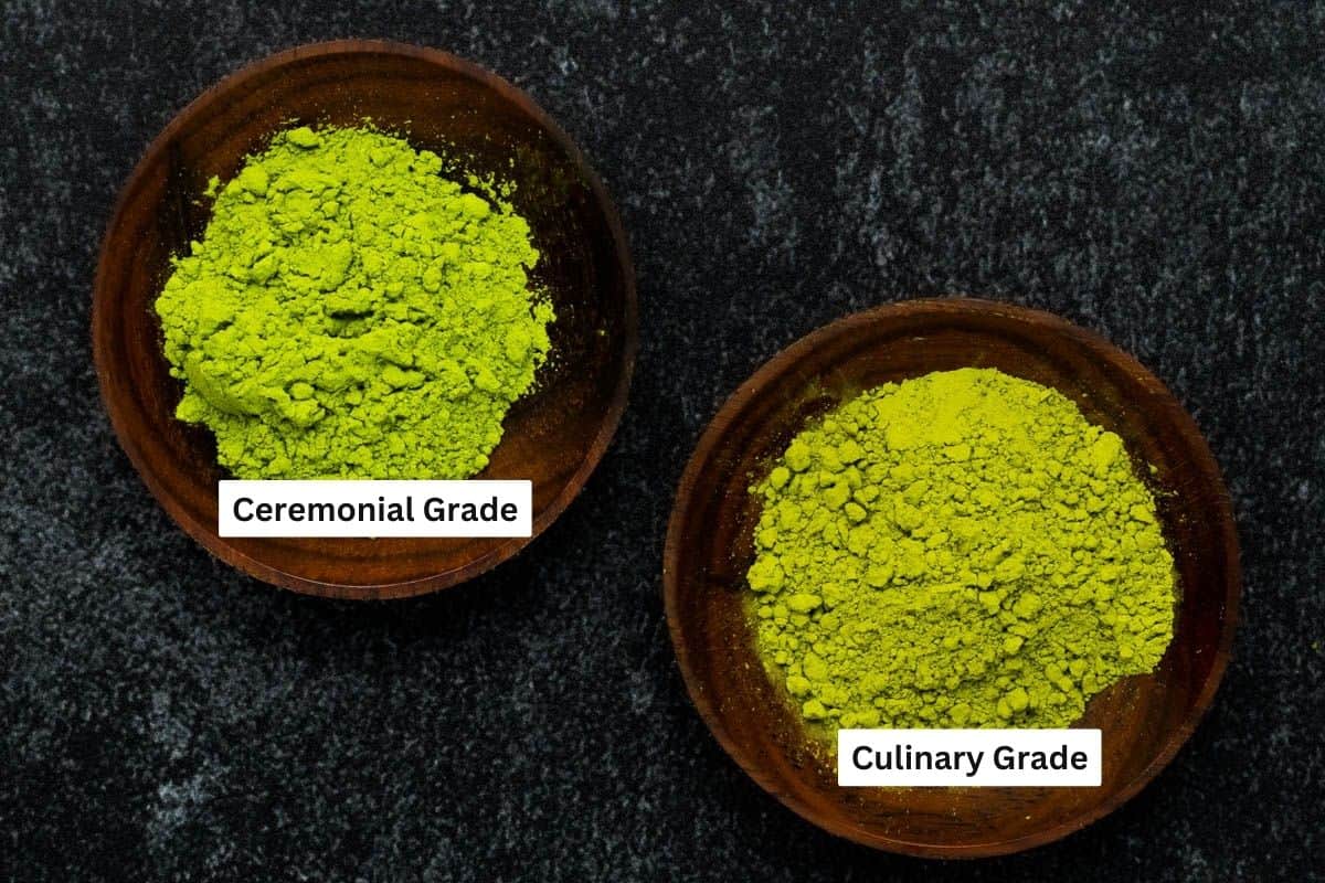 Two different grades of matcha tea powder in separate wood bowls labeled by quality.