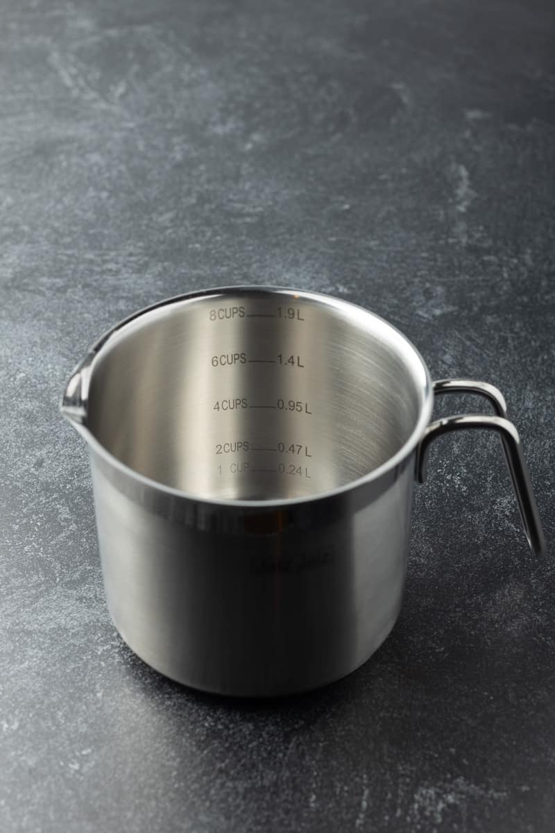 Stainless steel saucepan with a curved handle.