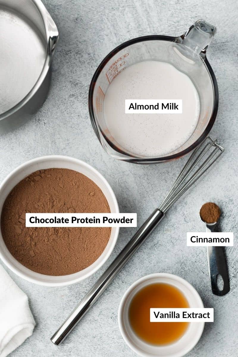 Protein hot chocolate ingredients in separate containers with labels.