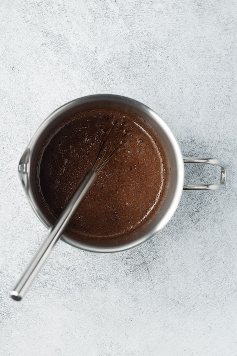 Whisked protein hot chocolate in a small pot.