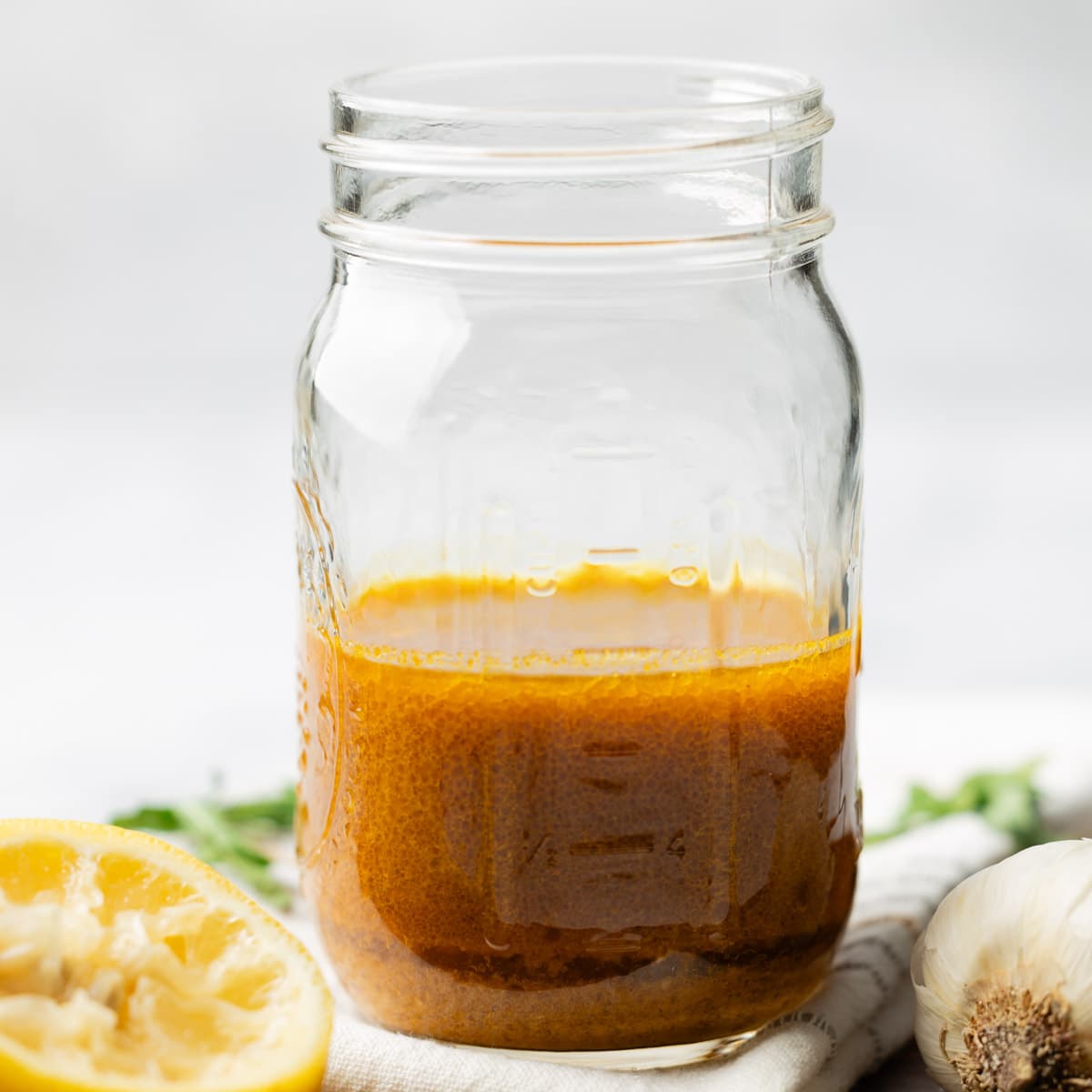 Finished curry salad dressing in a mason jar.