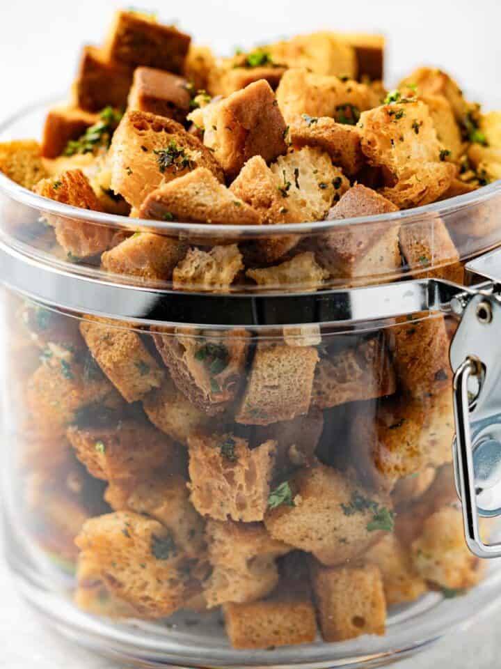 Gluten-free croutons in a clear plastic jar.