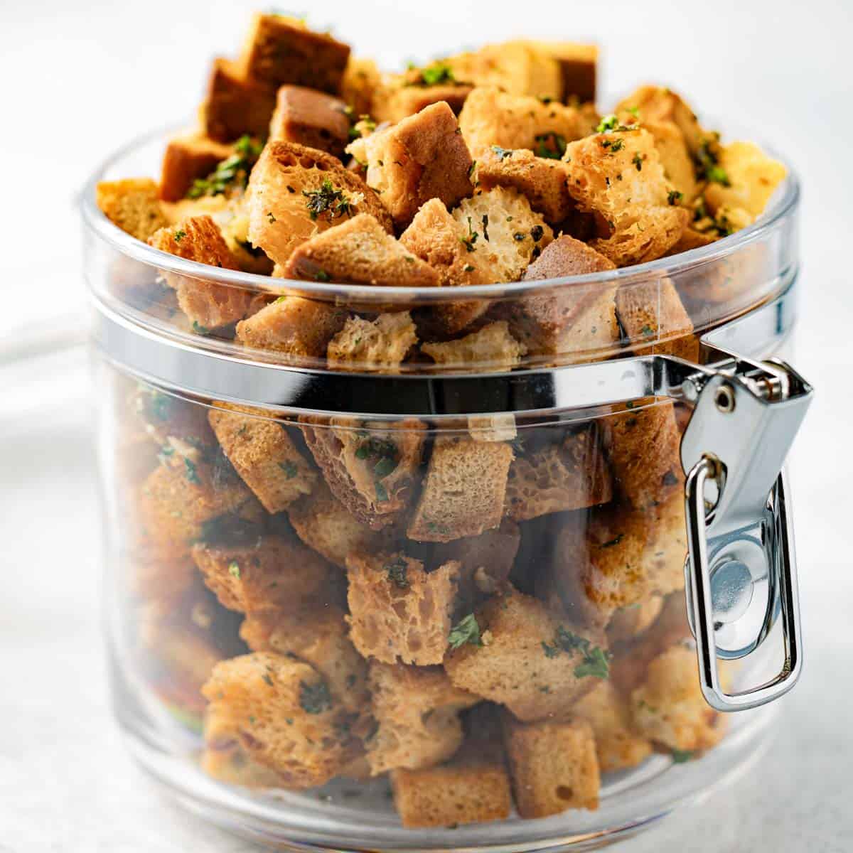 Gluten-free croutons in a clear plastic jar.