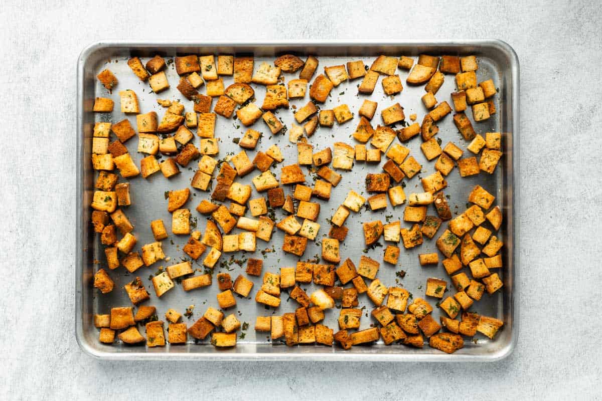 Baked bread cubes on a baking sheet.