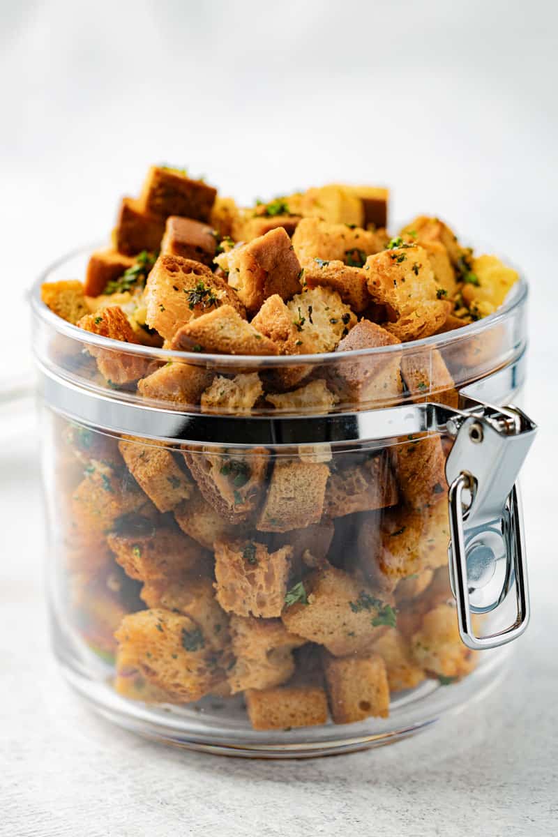 Gluten-free croutons in a clear plastic jar.