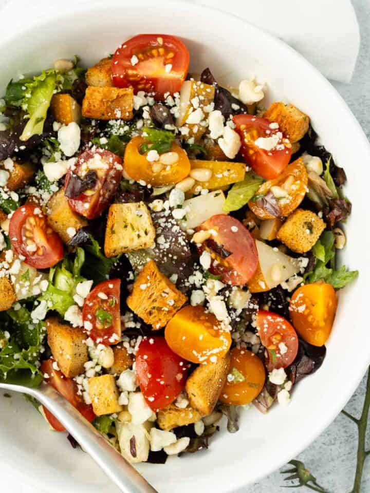 Asian pear salad in a white bowl.