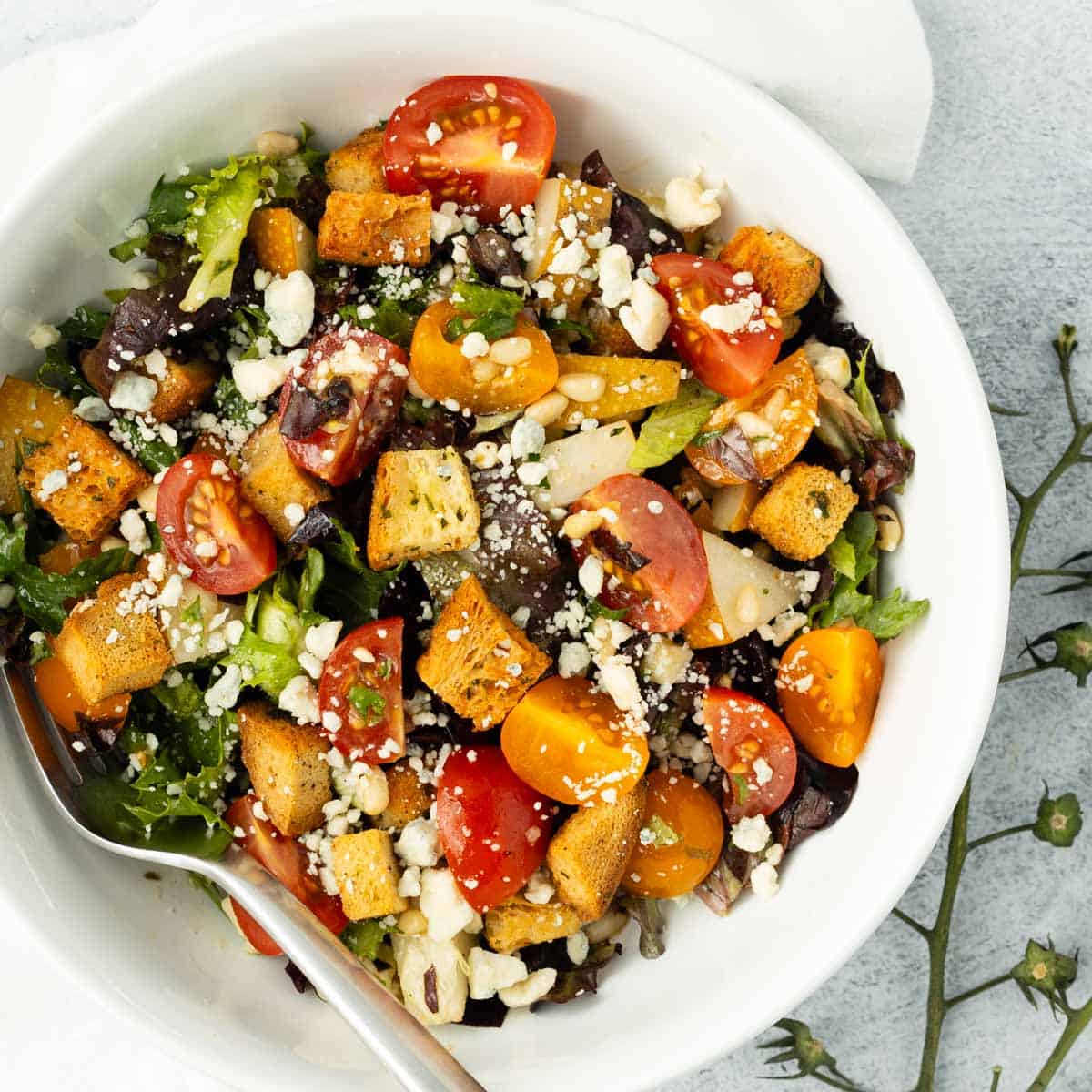 Asian pear salad in a white bowl.