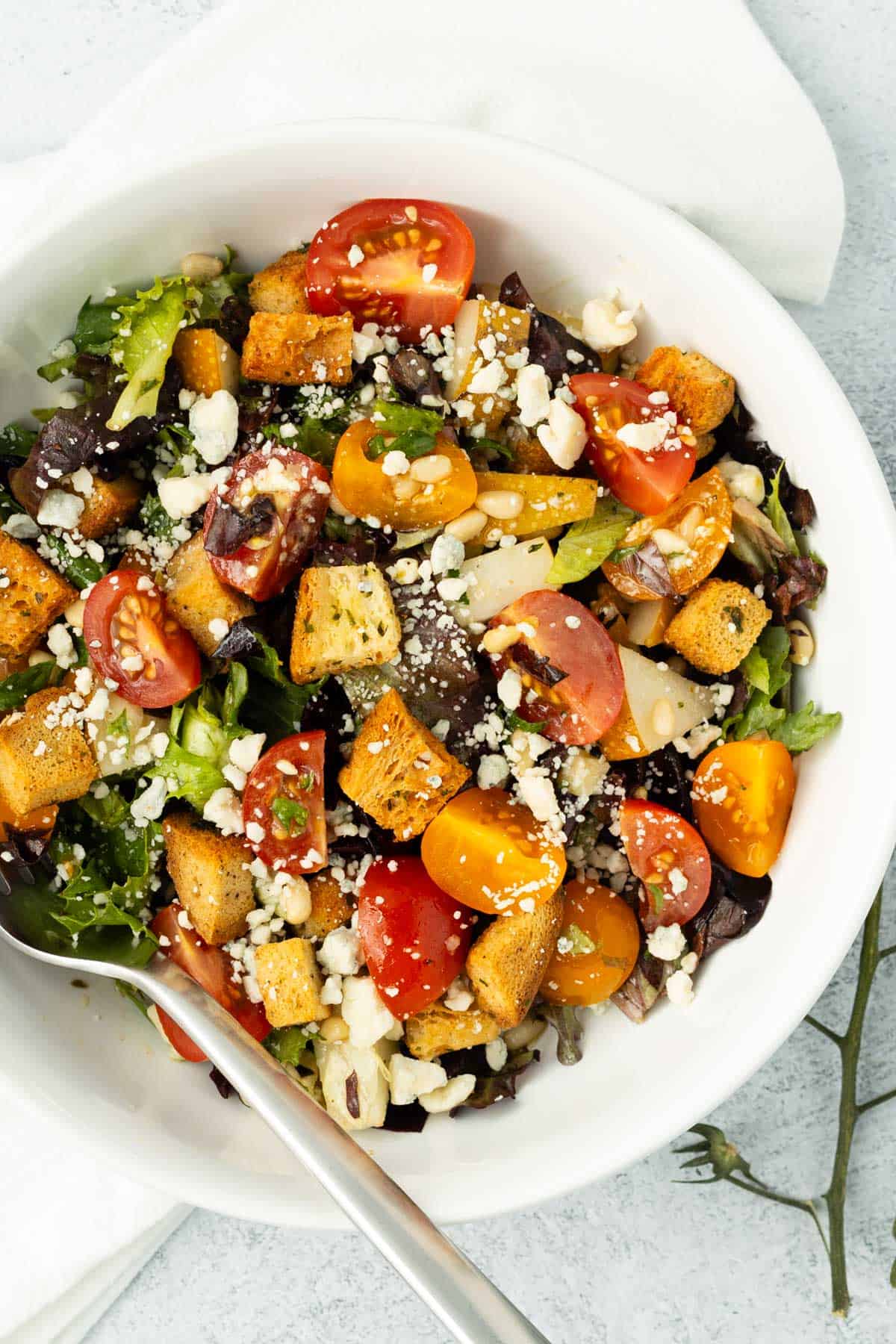 Asian pear salad in a white bowl.