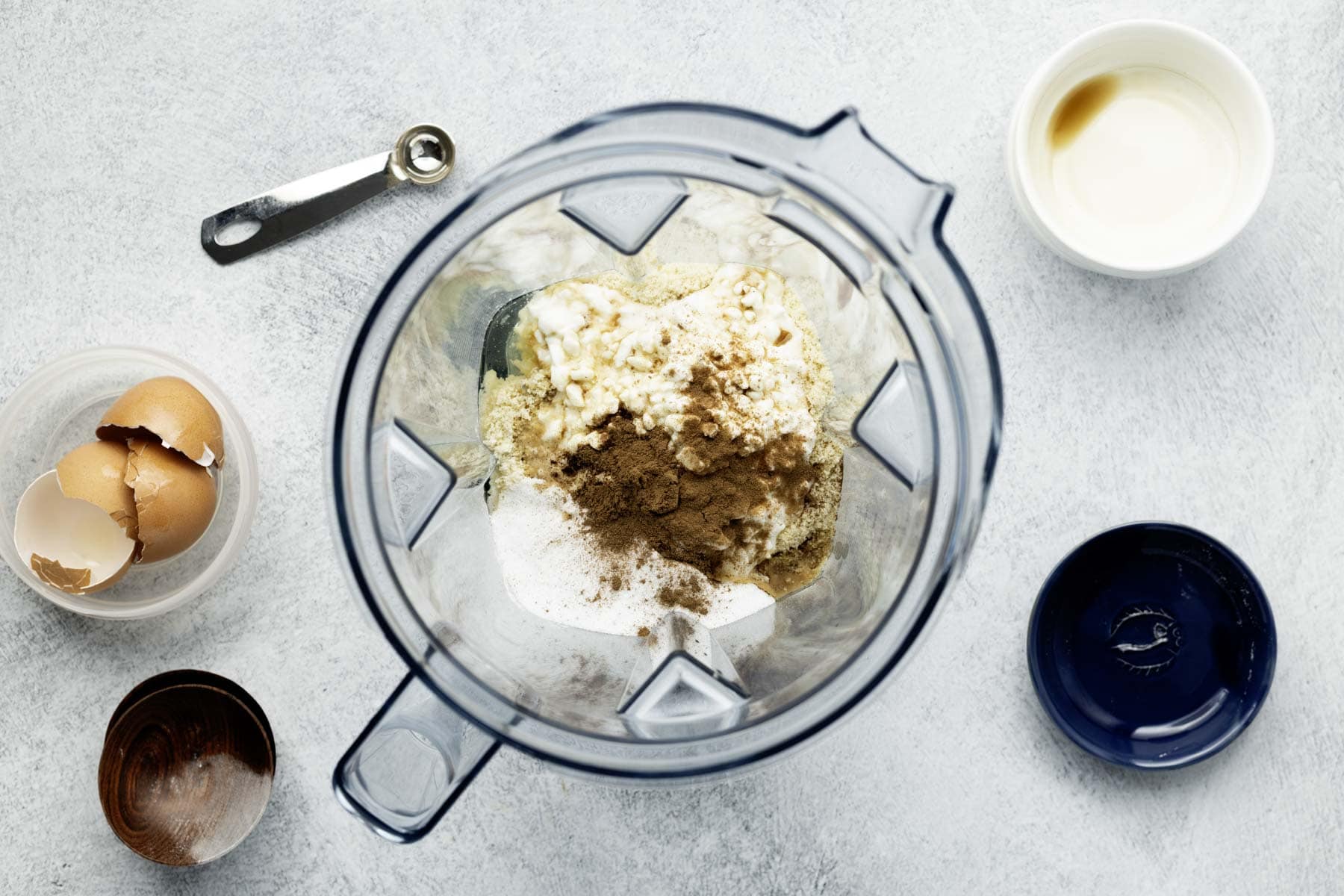Pancake ingredients added to clear plastic blender pitcher, ready to blend.
